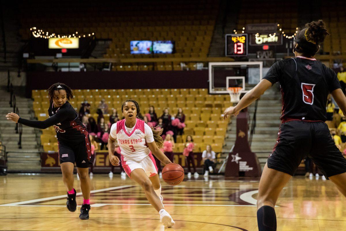 Texas State senior guard Kennedy Taylor (3) dribbles through the Ragin Cajuns defense during a game against the University of Louisiana, Thursday, Feb. 10, 2022, at Strahan Arena. The Bobcats won in OT 72-71.