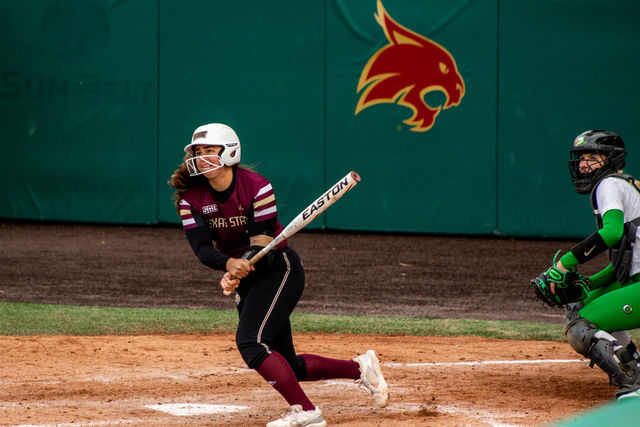 Texas State graduate infielder Dani Elder (2) watches the ball after making contact during the home opener against the University of Oregon, Thursday, Feb. 17, 2022, at Bobcat Softball Stadium. The Bobcats lost 3-7.