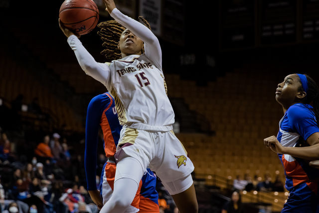 Texas State senior guard JaKayla Bowie (15) goes up for a basket during a game against UT Arlington, Saturday, Jan. 22, 2022, at Strahan Arena. The Bobcats lost 72-65.
