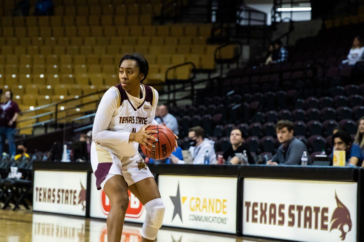 Texas State sophomore guard Sierra Dickson (4) looks for an open teammate to pass the ball to during a game against Coastal Carolina, Saturday, Feb. 5, 2022, at Strahan Arena. The Bobcats won 64-59.