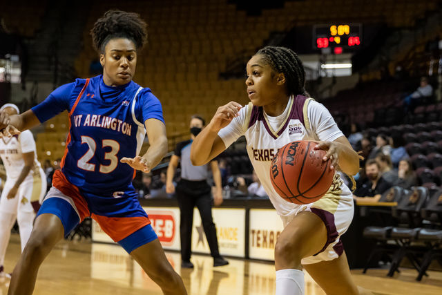 Texas State senior guard Kennedy Taylor (3) dribbles around a Maverick defender to get to the basket during a game against UT Arlington, Saturday, Jan. 22, 2022, at Strahan Arena. The Bobcats lost 72-65.