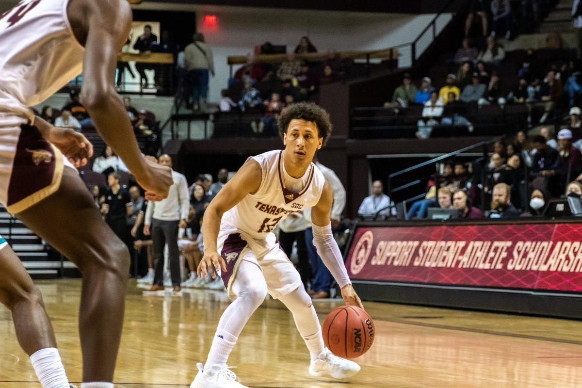 Texas State senior guard Mason Harrell (12) looks for an open teammate to pass the ball to during a game against Coastal Carolina, Sat. Feb 5, 2022, at Strahan Arena. The Bobcats won 69-64.