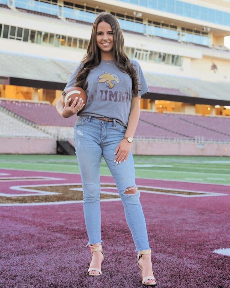 Texas State Director of Football Operations Haleigh Blocker stands on the sidelines at Bobcat Stadium. Blocker graduated from Texas State in 2019 and is the second woman to hold the role of football operations director.