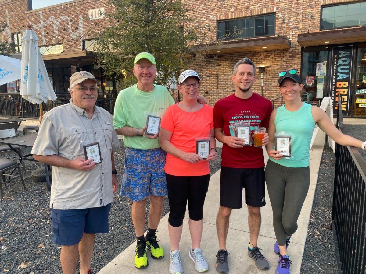 Members of the San Marcos Runners Club pose for a photo on Thursday, March 3, 2022, in front of AquaBrew, their current meeting place. These members are recipients of the Moe Johnson Mileage Award Program.