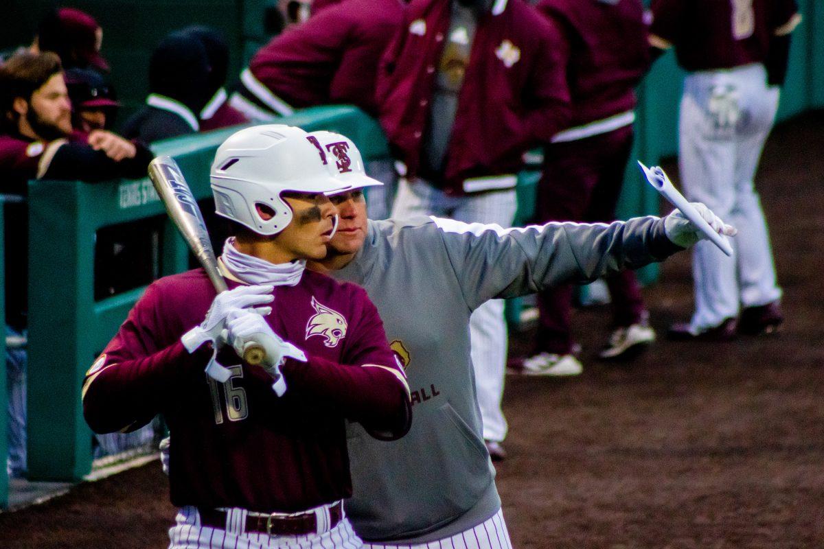 Texas State baseball head coach Steven Trout coaches freshman infielder Daylan Pena (16) before Pena goes up to bat during a game against Wichita State, Thursday, Feb. 24, 2022, at Bobcat Ballpark. The Bobcats won 9-2.