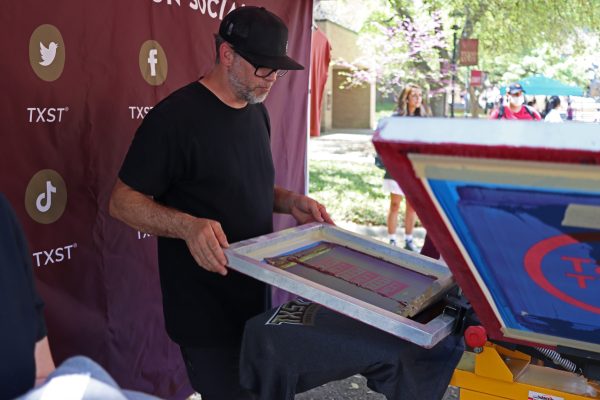Print This owner John Powell prints shirts, Tuesday, April 5, 2022, at the Quad. John is printing shirts to promote Texas State's new branding "TXST NEXT."
