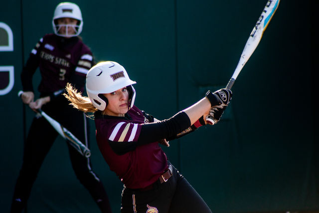 Texas State sophomore infielder Claire Ginder (8) swings at a pitch from a Duck during the home opener against the University of Oregon, Thursday, Feb. 17, 2022, at Bobcat Softball Stadium. The Bobcats lost 3-7.