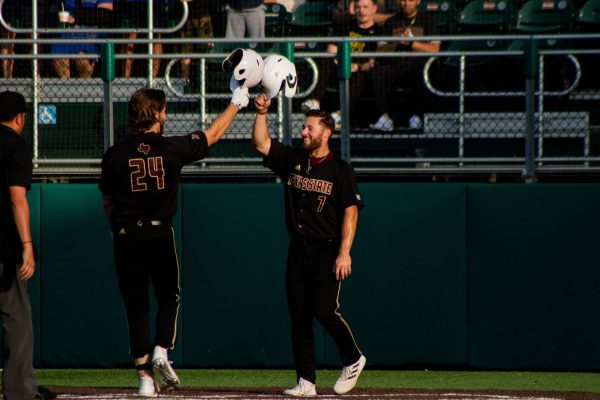 Texas State senior infielder Wesley Faison (24) and senior outfielder John Wuthrich (7) celebrate their runs at home plate during a game against Baylor, Tuesday, April 12, 2022, at Bobcat Ballpark. The Bobcats won 11-4. Faison hit a home run bringing in Wuthrich and himself to score.