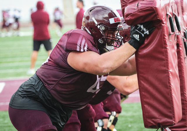 Texas State graduate offensive lineman Liam Dobson (69) pushes against training equipment during fall camp drills, Thursday, Aug. 12, 2021, at Bobcat Stadium.