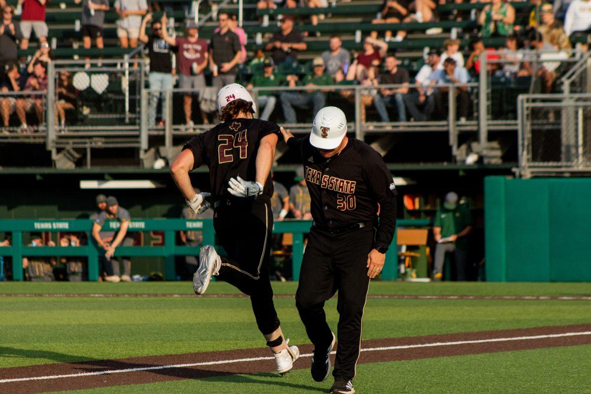 Texas State senior infielder Wesley Faison (24) high-fives head coach Steven Trout while running the bases after hitting a home run during a game against Baylor, Tuesday, April 12, 2022, at Bobcat Ballpark. The Bobcats won 11-4.