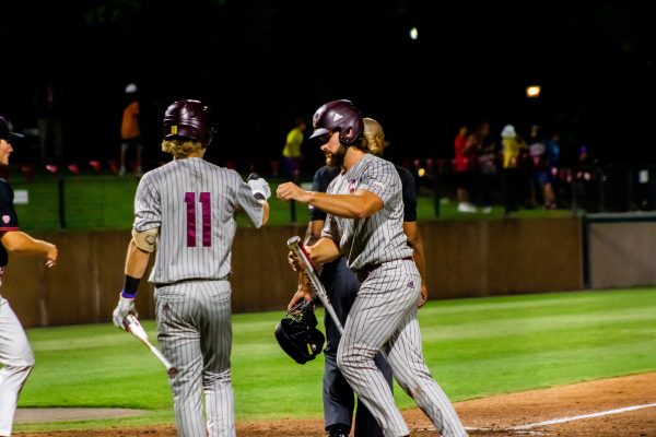 Texas State senior designated hitter Wesley Faison (24) fist bumps senior infielder Cameron Gibbons (11) after scoring a run during a game against Stanford in the NCAA Stanford Regional, Sunday, June 5, 2022, at Klein Field at Sunken Diamond in Palo Alto, CA. The Bobcats lost 8-4.