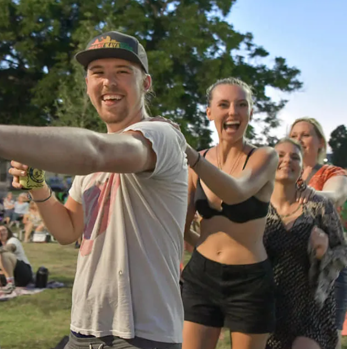Attendees dance in a conga line at Summer in the Park.