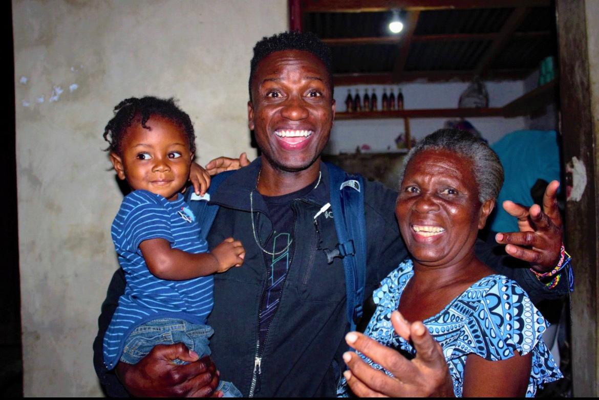 Jimmy Amisial (center) visits his son Emilio and family in Gonaives, Haiti. 