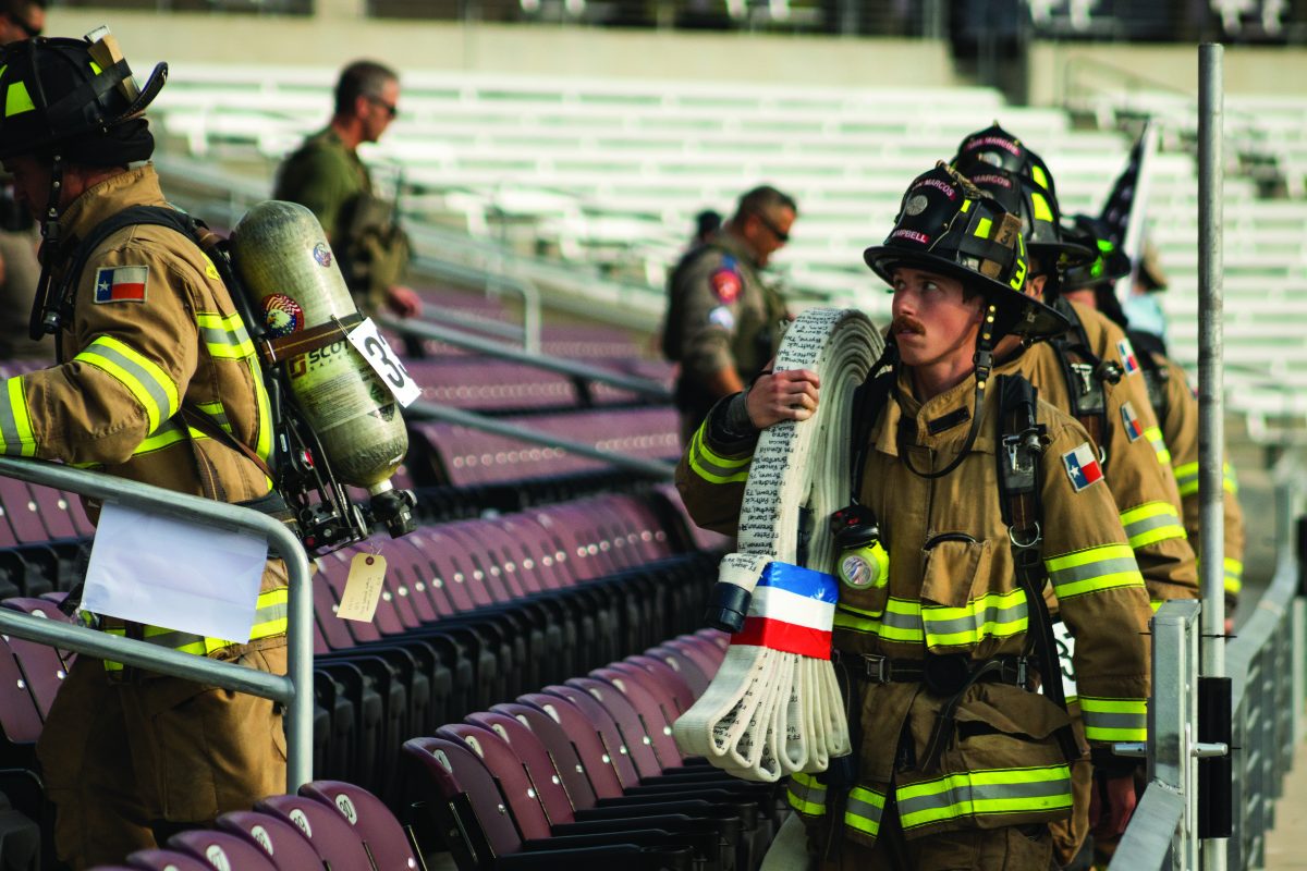 San Marcos Firefighter Aidan Cambell carries a fire hose with the written names of all the deceased 9/11 first responders during the 2nd annual Hays County 9/11 Memorial Stair Climb, Sunday, Sep. 11, 2022, at Bobcat Stadium.