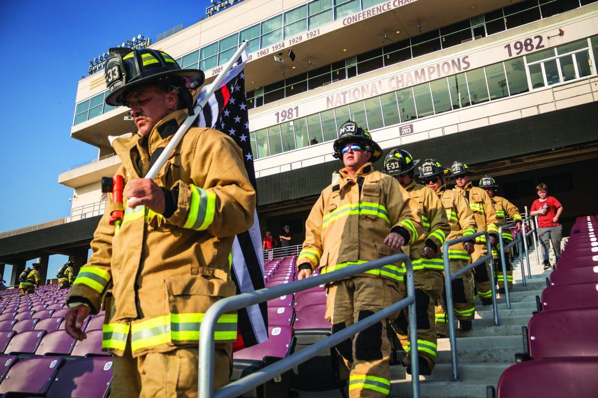 San Marcos firefighters and Department of Public Safety officers walk down the steps of Bobcat Stadium in full uniform, Sunday, Sept. 11, 2022, at the 2nd annual Hays County 9/11 Memorial Stair Climb.