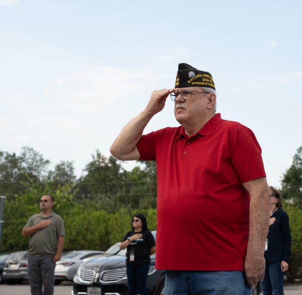 U.S. Navy veteran David Adams salutes the flag during a moment of silence, Friday, Sept. 9, 2022, at San Marcos City Hall.