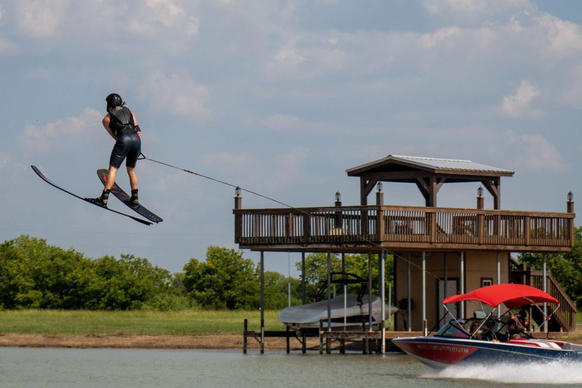 Texas State accounting senior Cody Overtire jumps off a ramp during water ski practice, Friday, Sept. 23, 2022, at the San Marcos River Ranch.