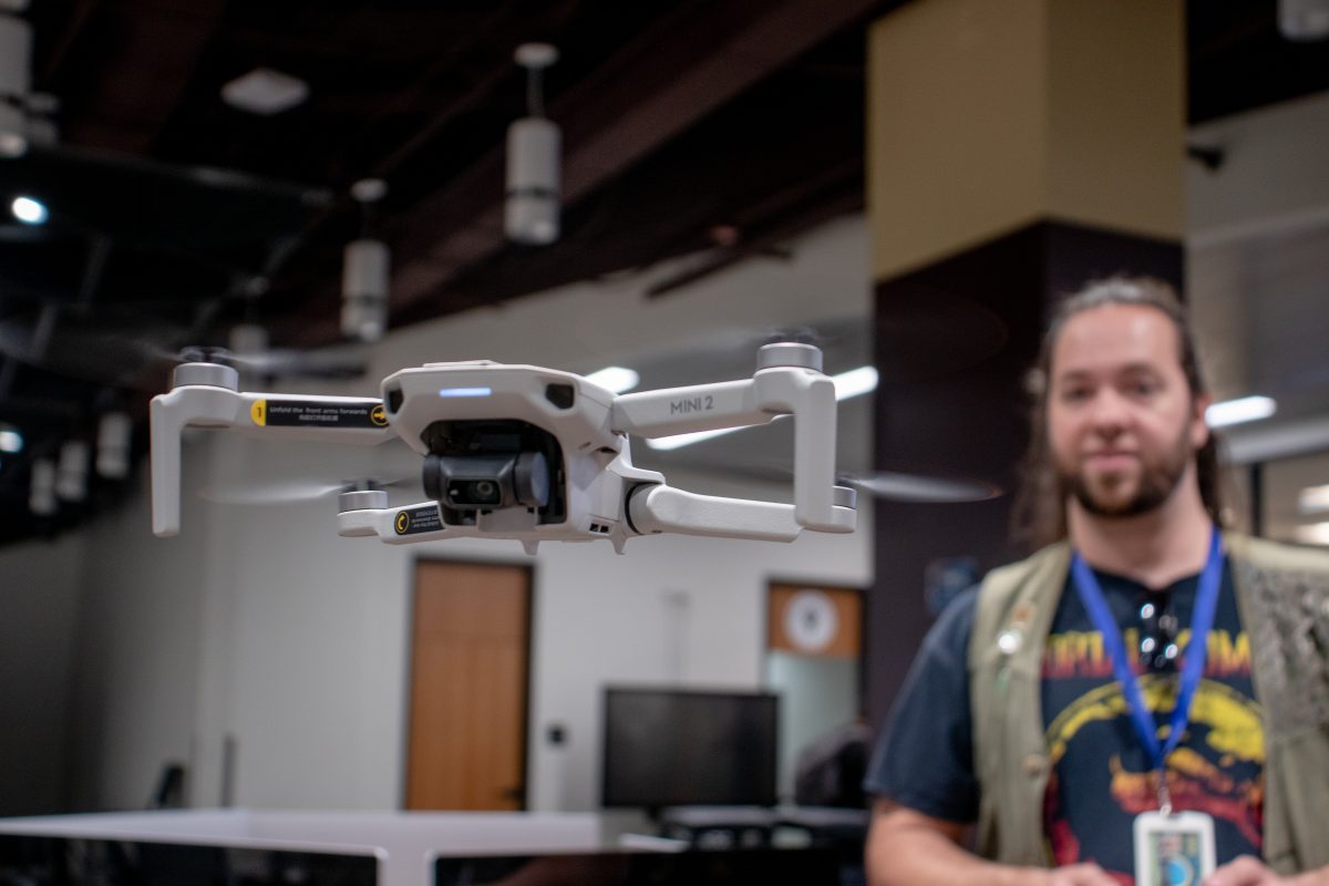 Alkek Ones MakerSpace manager WIlliam Cates flies a DJI Mavic Mini 2 during the Alkek One 2nd year birthday party, Thursday, Sept. 8, 2022, in front of the ITAC office.