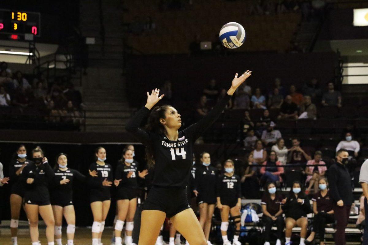 Texas State junior setter Ryann Torres (14) serves the ball to a Hurricanes opponent, Friday, Sept. 10, 2021, at Strahan Arena. The Bobcats lost 3-0 against the University of Miami. 
