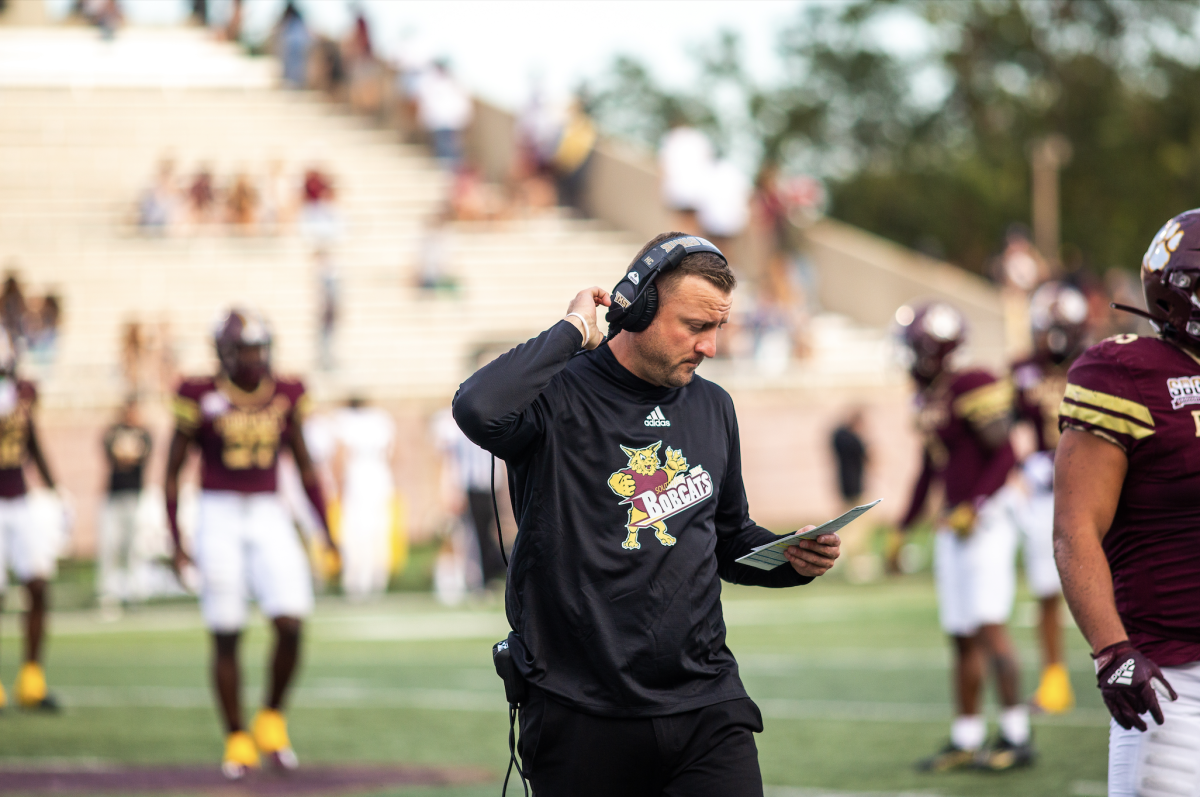 Texas State head football coach Jake Spavital goes over the playbook during a game against the University of Southern Mississippi, Saturday, Oct. 22, 2022, at Bobcat Stadium. The Bobcats lost 20-14.