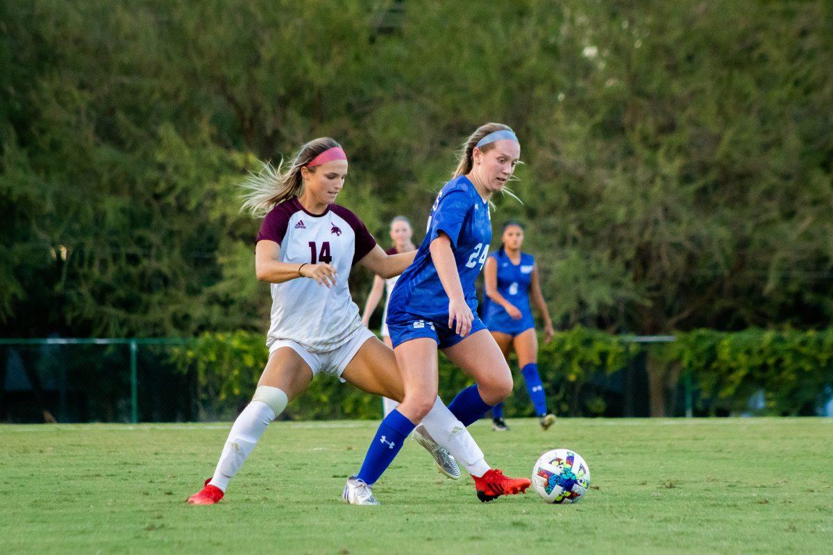 Texas State sophomore defender Anna Dunch (14) attempts to steal possession of the ball from Huskies senior midfielder Ryan Ford (24) in a game against Houston Baptist, Sunday, August 28, 2022, at Bobcat Soccer Complex. The Bobcats won 2-1.