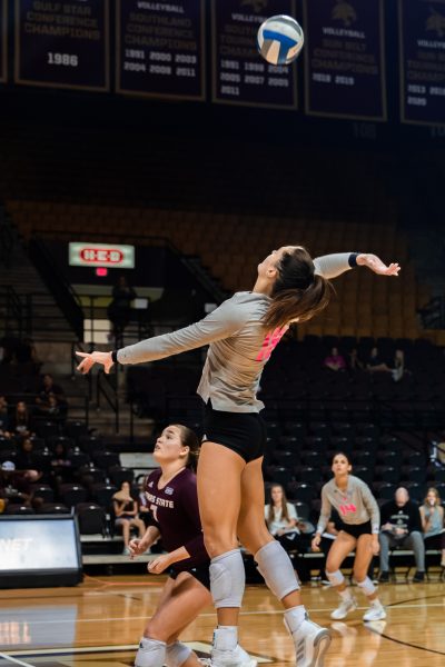 Texas State senior outside hitter Lauren Teske (18) goes up to hit the ball over the net during a match against James Madison University, Saturday, Oct. 1, 2022, at Strahan Arena. The Bobcats tied the weekend series 1-1.