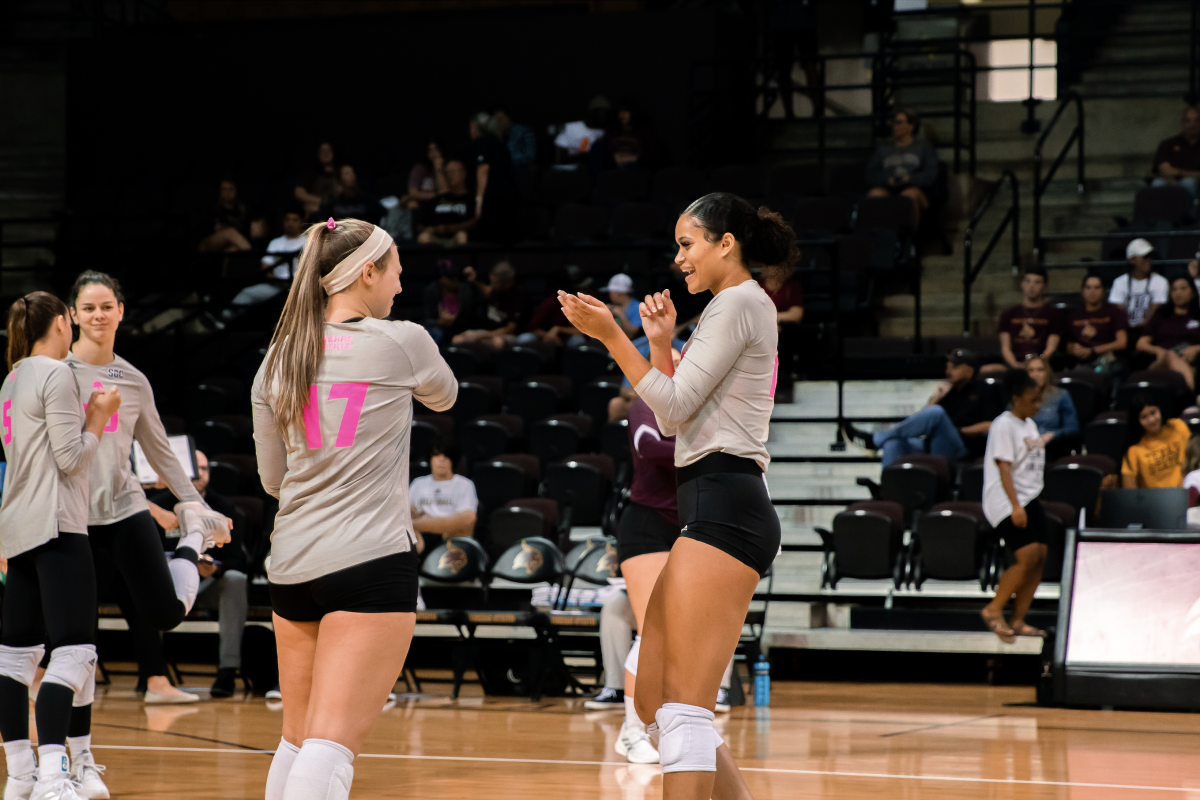 Texas State graduate student outside hitter Janell Fitzgerald (16) celebrates with her teammates during a match against James Madison University, Saturday, Oct. 1, 2022, at Strahan Arena.