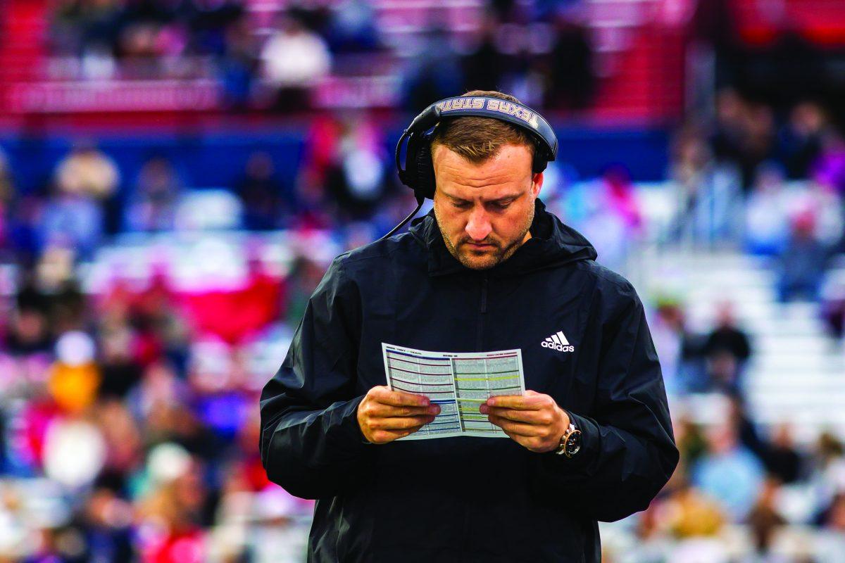 Texas State football head coach Jake Spavital scans his playbook in a game against South Alabama, Saturday, Nov. 12, 2022, at Hancock Whitney Stadium. The Bobcats lost 38-21. 