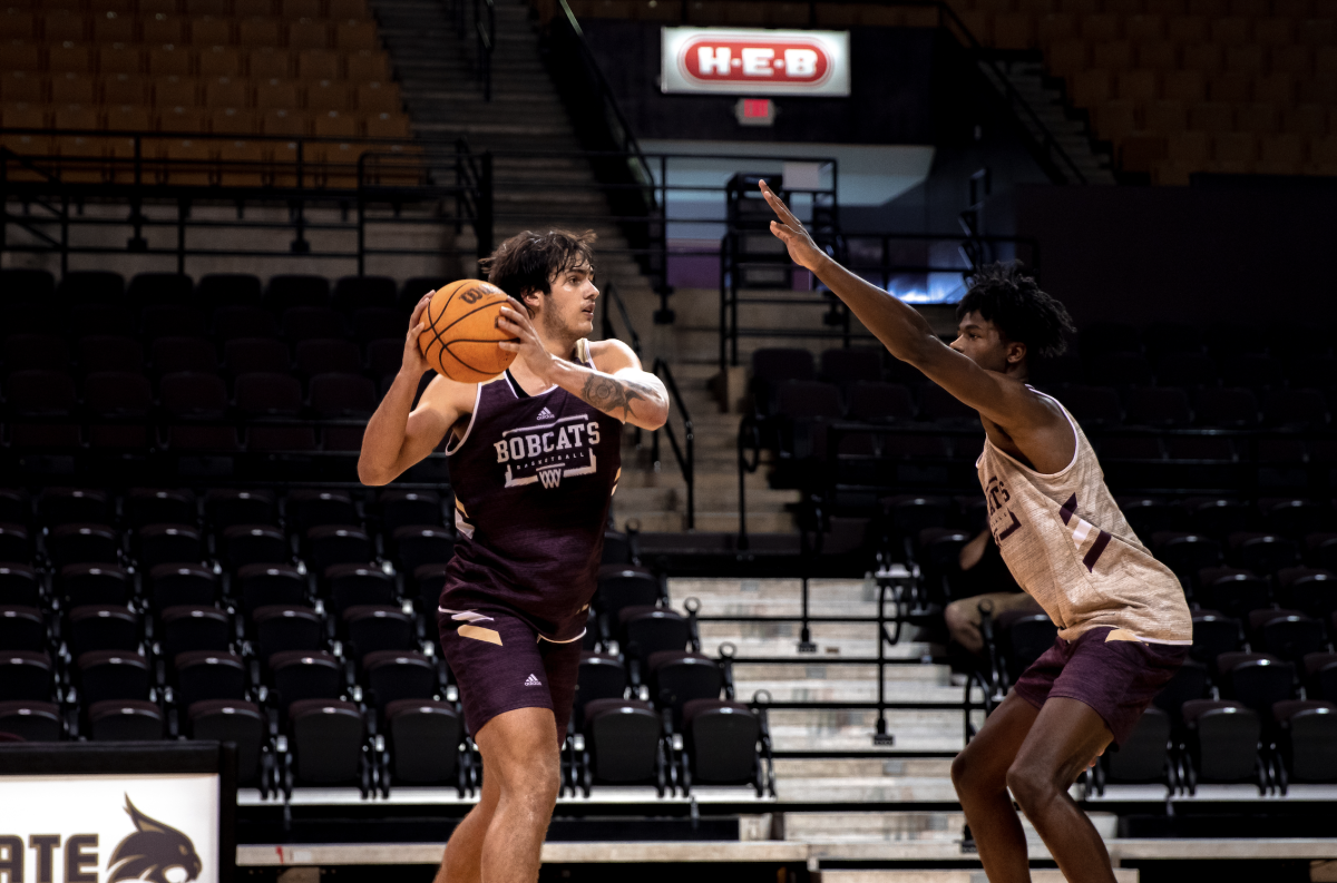 Texas State junior forward Nate Martin (11) looks for an open pass around sophomore forward Brandon Love (24) during the first public mens basketball practice, Friday, Oct. 21, 2022, at Strahan Arena. 
