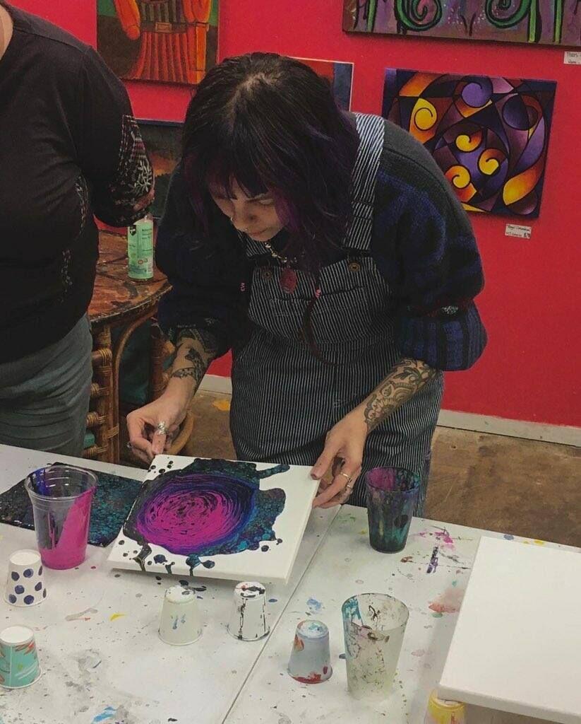 Local artist MJ demonstrates the techniques of fluid art during the Fluid Art Workshop, Friday Dec. 16, 2022 at Studio San Martian.