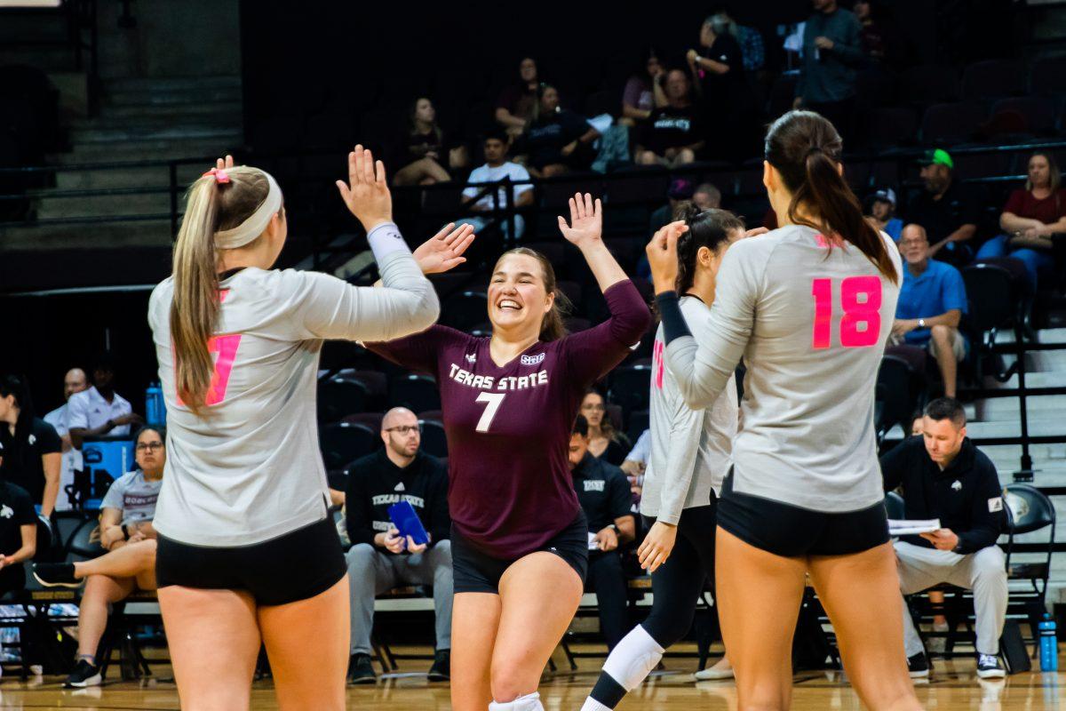 Texas State sophomore defensive specialist Jacqueline Lee (7) celebrates with teammates during a match against James Madison University, Saturday, Oct. 1, 2022, at Strahan Arena. The Bobcats tied the weekend series 1-1. 