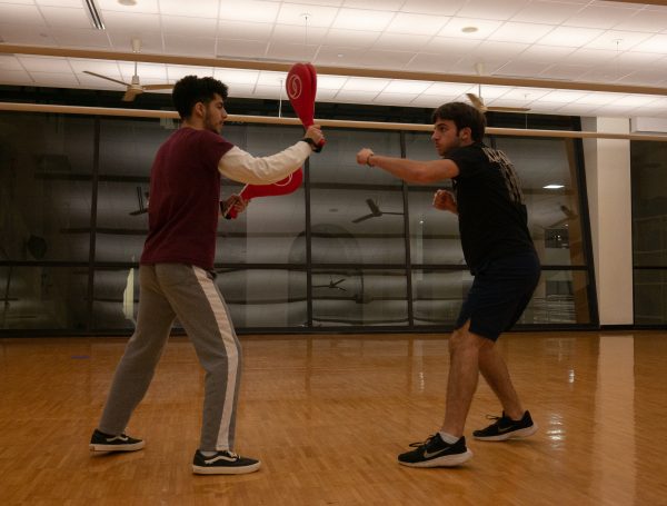 Texas State exercise and sport science sophomore Leo Arellano (left) practices combo drills with mechanical engineering freshman Reece Cavallo, Friday, Feb. 3, 2023, at Texas State Recreational Center.