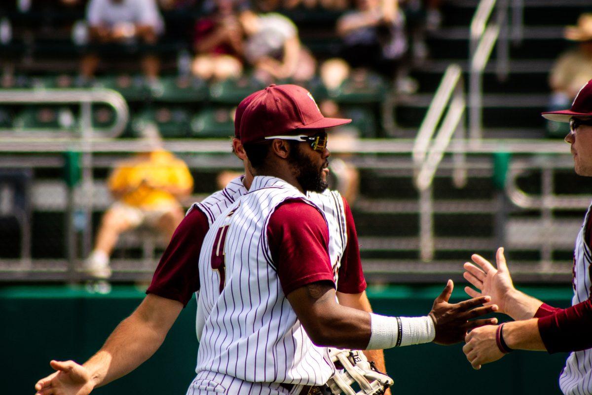 Texas State junior outfielder Ben McClain (4) high fives his teammates after coming off the field during a game against Coastal Carolina, Sunday, March 27, 2022, at Bobcat Ballpark. The Bobcats won the weekend series 2-1.