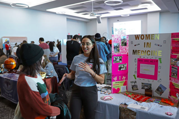 Texas State biology senior Marianna Saucedo (right) provides information to psychology sophomore Hannah Lee about the Women in Medicine Club, Thursday, Jan. 26, 2023, at the LBJ Ballroom. Texas States Organization Fair allows students to find like-minded groups to network with and join a community.