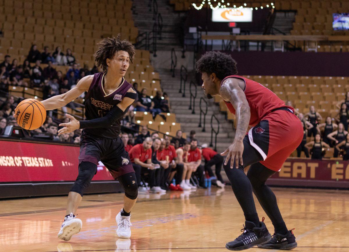 Texas State senior guard Mason Harrell (12) looks to pass the ball against Arkansas State University, Thursday, Feb. 9, 2023, at Strahan Arena. The Bobcats won 66-62.