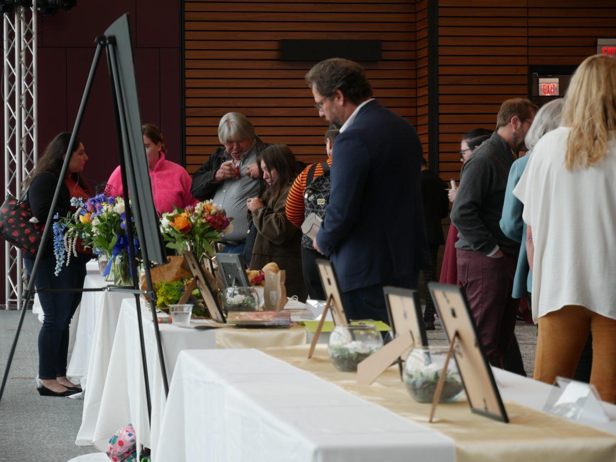 Attendees of Bobcat Pause go around the room to each display and learn about the lives of the honorees, Thursday, April 6, 2023, in the LBJ Grand Ballroom.