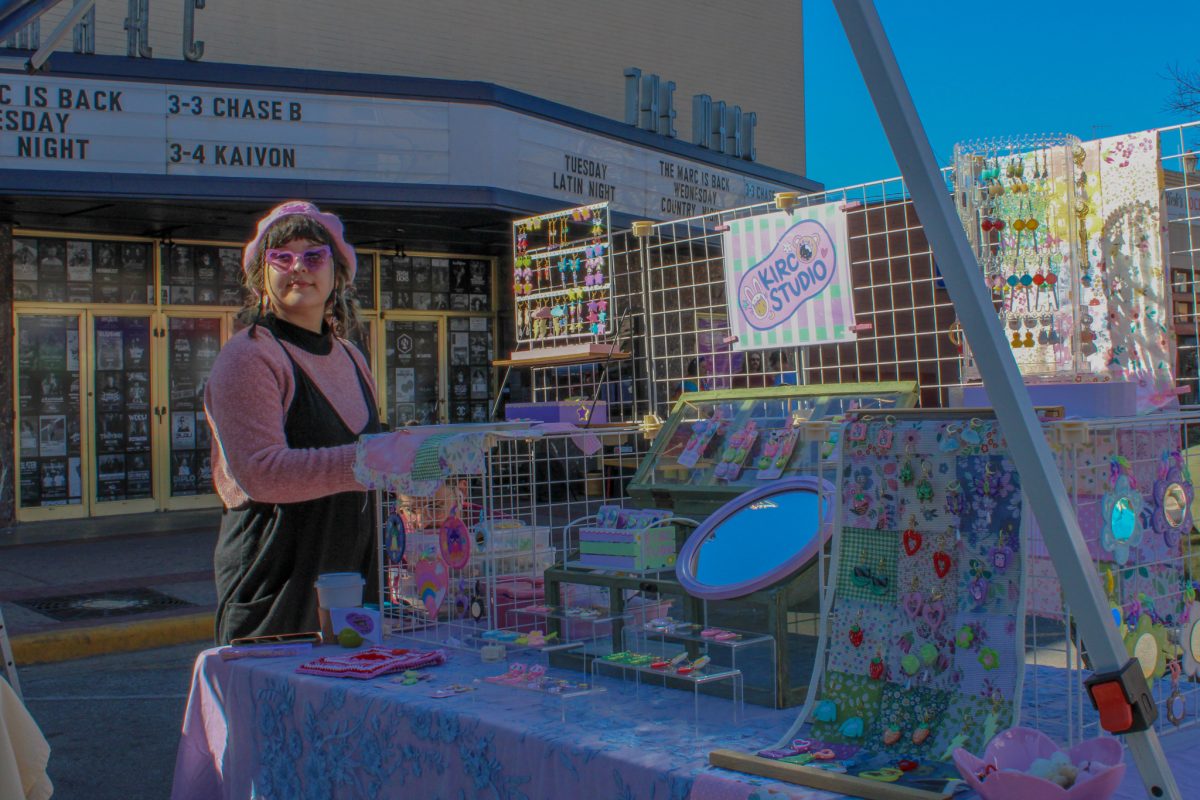Texas State ceramics alumna Kiana Valtierra sets up her booth, Saturday, March 4, 2023, at the San Marcos Farmers Market.