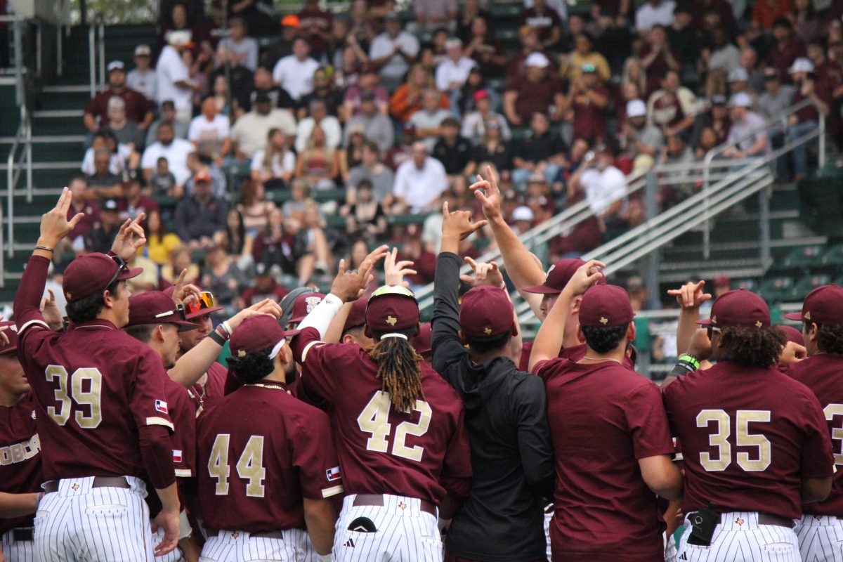 Texas State Baseball team walks onto the field before the game before Texas with their hands high, Monday, April 10, 2023, at Bobcat Ballpark.