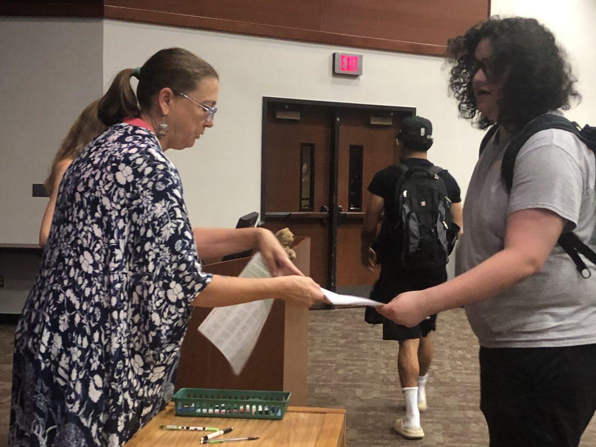 Texas State tenured professor Jill Pruetz takes a final exam from student to be graded, Monday, May 8,2023, in LBJ Teaching Theater.