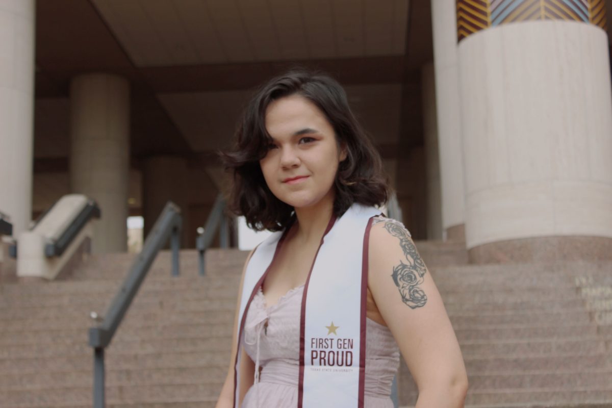 Texas State English senior poses for her graduation photos, Tuesday, May 2, 2023 in front of Alkek Library.