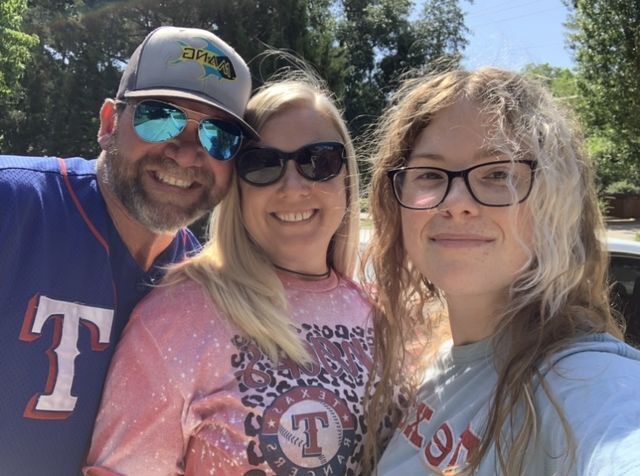 Texas State journalism senior poses for photo with her parents, May 18, 2022 in Arlington, Texas. 