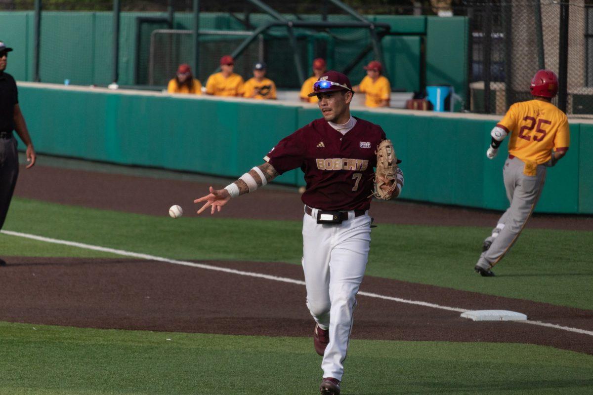 Texas State infielder sophomore Daylan Pena (7) tosses baseball after tagging out a Louisiana-Monroe player, May 18, 2023, at Bobcat Ballpark. Texas State won 6-5.