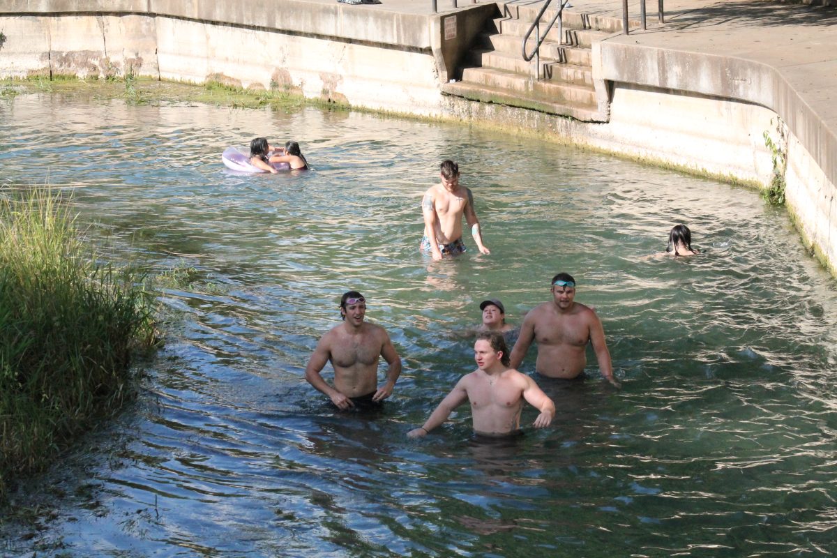 Sewell-goers walk in the river due to low river levels, Saturday, July 8, 2023, at the San Marcos River in San Marcos