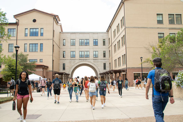 Texas State students walk by the Arch, Monday, August 23, 2021, at the UAC.