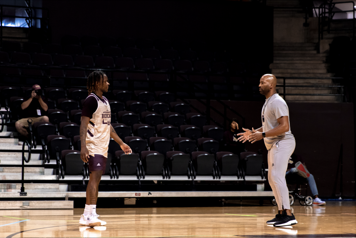 Texas+State+junior+guard+Brandon+Davis+receives+instruction+from+assistant+coach+Donte+Mathis%2C+during+the+first+public+mens+basketball+practice%2C+Friday%2C+Oct.+21%2C+2022%2C+at+Strahan+Arena.