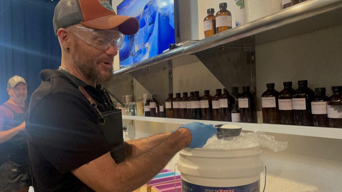 Kevin Douglas Smith scoops out lye powder, Sunday, Aug. 20, 2023, at Douglas Smith Soap Company in San Marcos.
