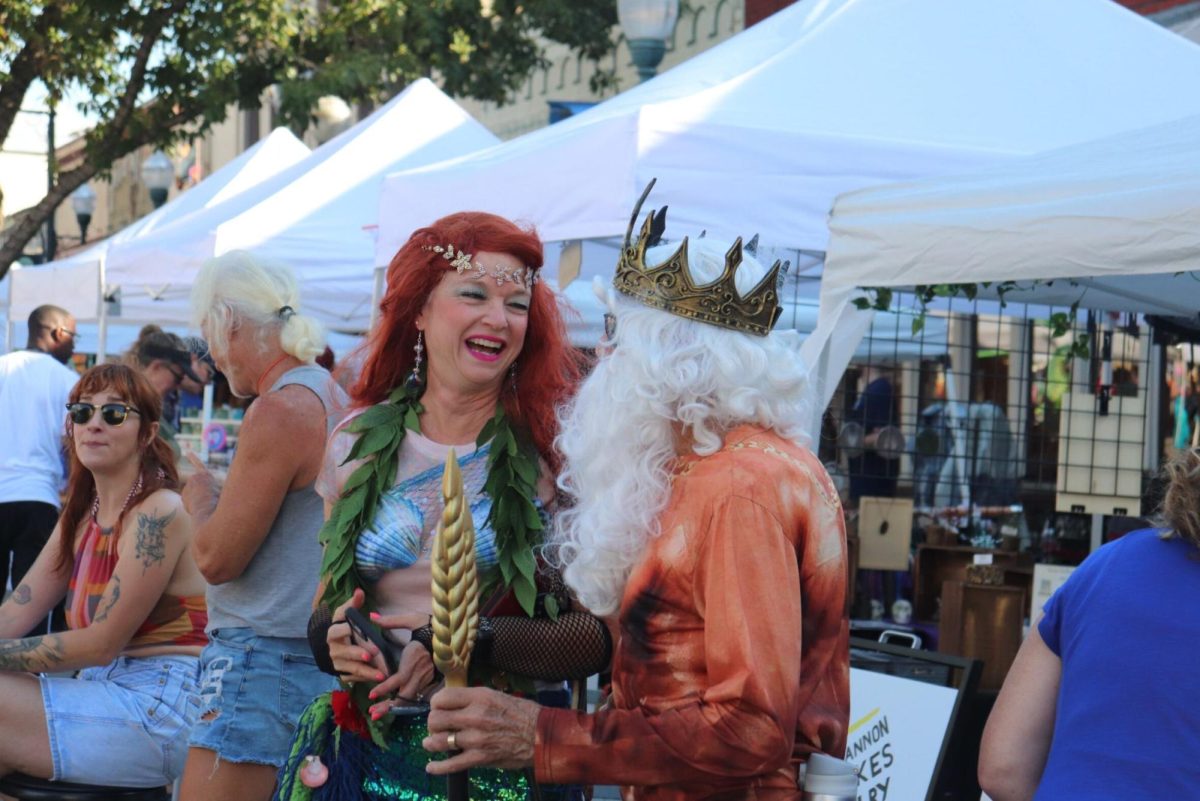 Festival goers share a laugh before the Mermaid Promenade starts, Saturday, Sept. 23, 2023, in San Marcos.
