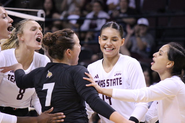The Texas State volleyball team celebrates a winning point, Saturday, Aug. 19, 2023, at Strahan Arena.