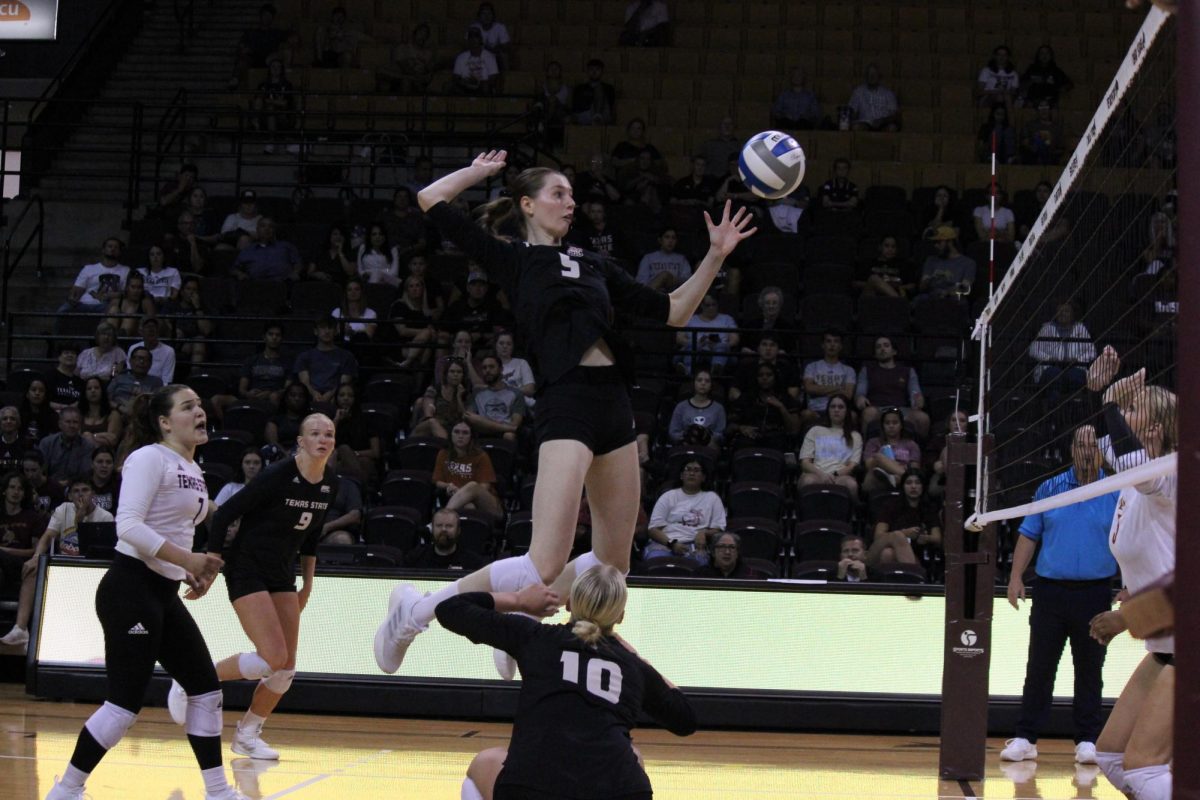 Texas State sophomore middle blocker Jade Defraeye (5) spikes the ball over the net, Thursday, Sept. 21, 2023, at Strahan Arena.