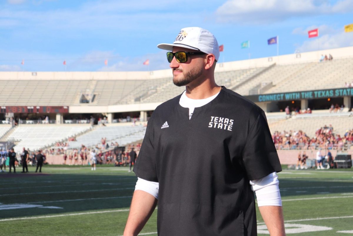 Texas State Head Coach G.J. Kinne walks onto the field before the game against Nevada, Saturday, Sept. 23, 2023, at Bobcat Stadium.